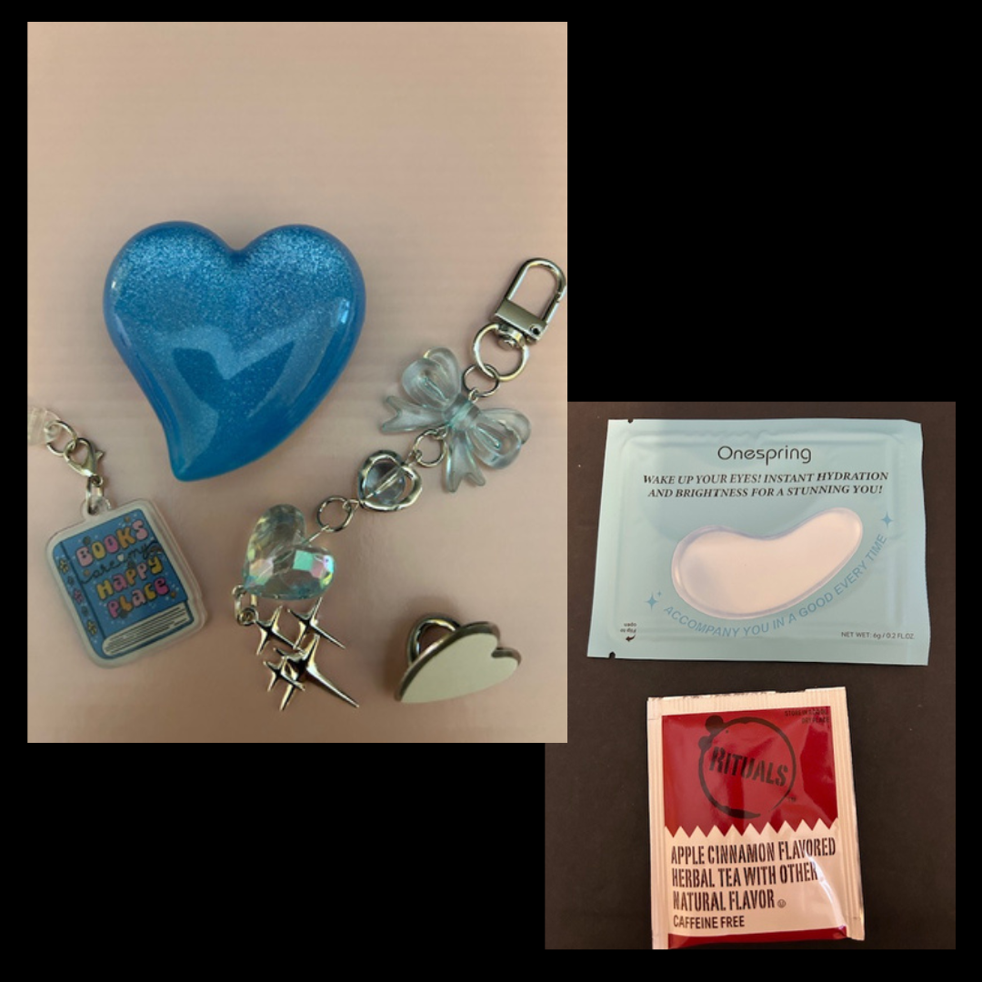 Collection of Kindle accessories including a blue heart-shaped object, keychain with charms, USB plug and more
